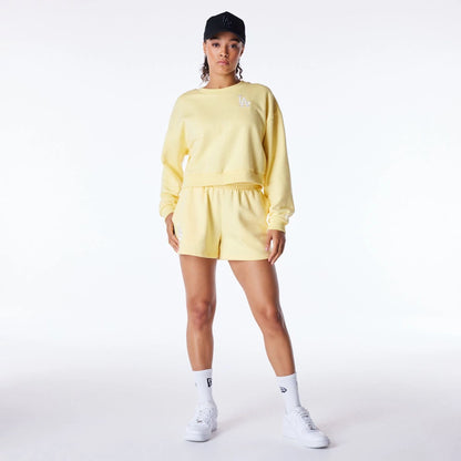 The Female model is wearing LA Dodgers Womens MLB League Essential Pastel Yellow Crop Crew Neck Sweatshirt 2