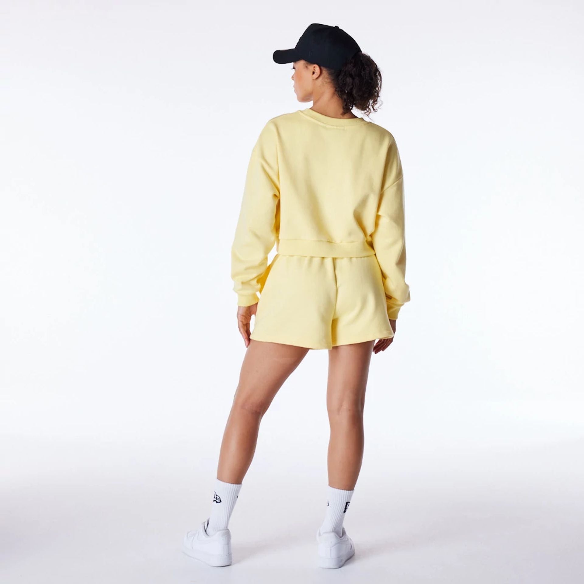 The Female model is wearing LA Dodgers Womens MLB League Essential Pastel Yellow Crop Crew Neck Sweatshirt 3