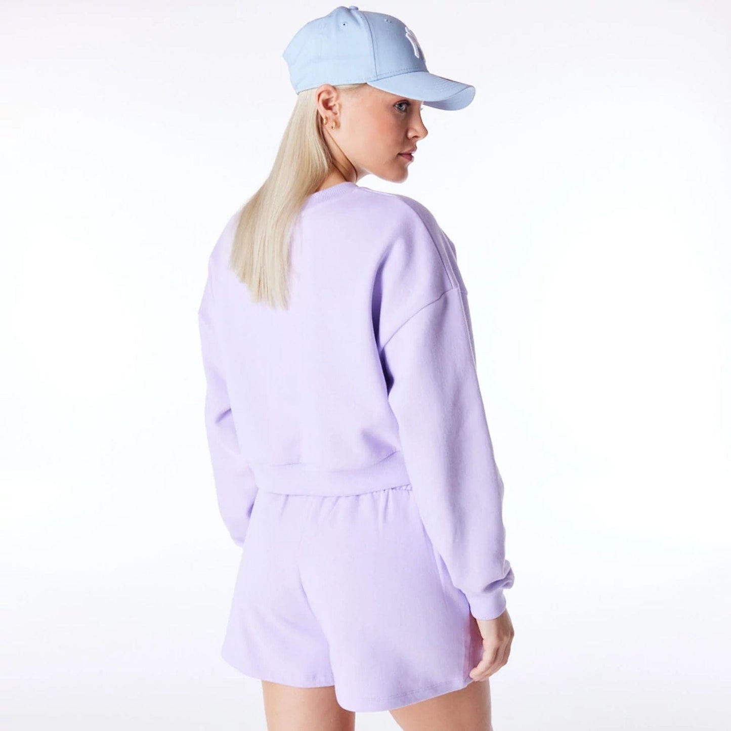 The Female model is wearing New York Yankees Womens MLB League Essential Pastel Purple Crop Crew Neck Sweatshirt 4