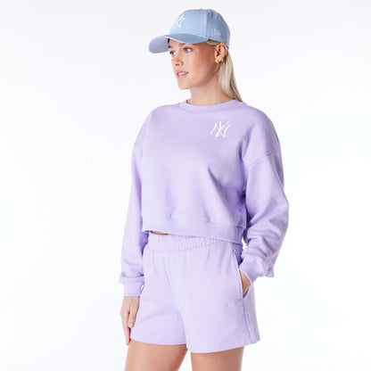 The Female model is wearing New York Yankees Womens MLB League Essential Pastel Purple Crop Crew Neck Sweatshirt 5