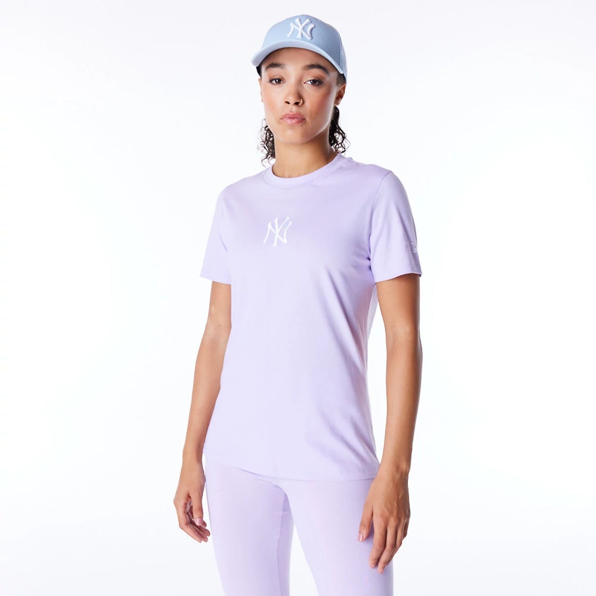 The Female model is wearing New York Yankees Womens MLB League Essential Pastel Purple T-Shirt 1