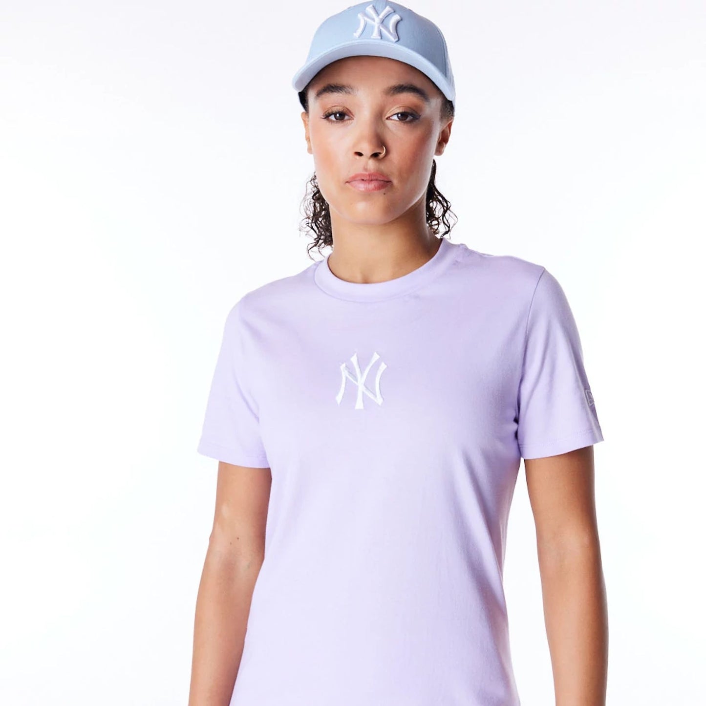 The Female model is wearing New York Yankees Womens MLB League Essential Pastel Purple T-Shirt 4