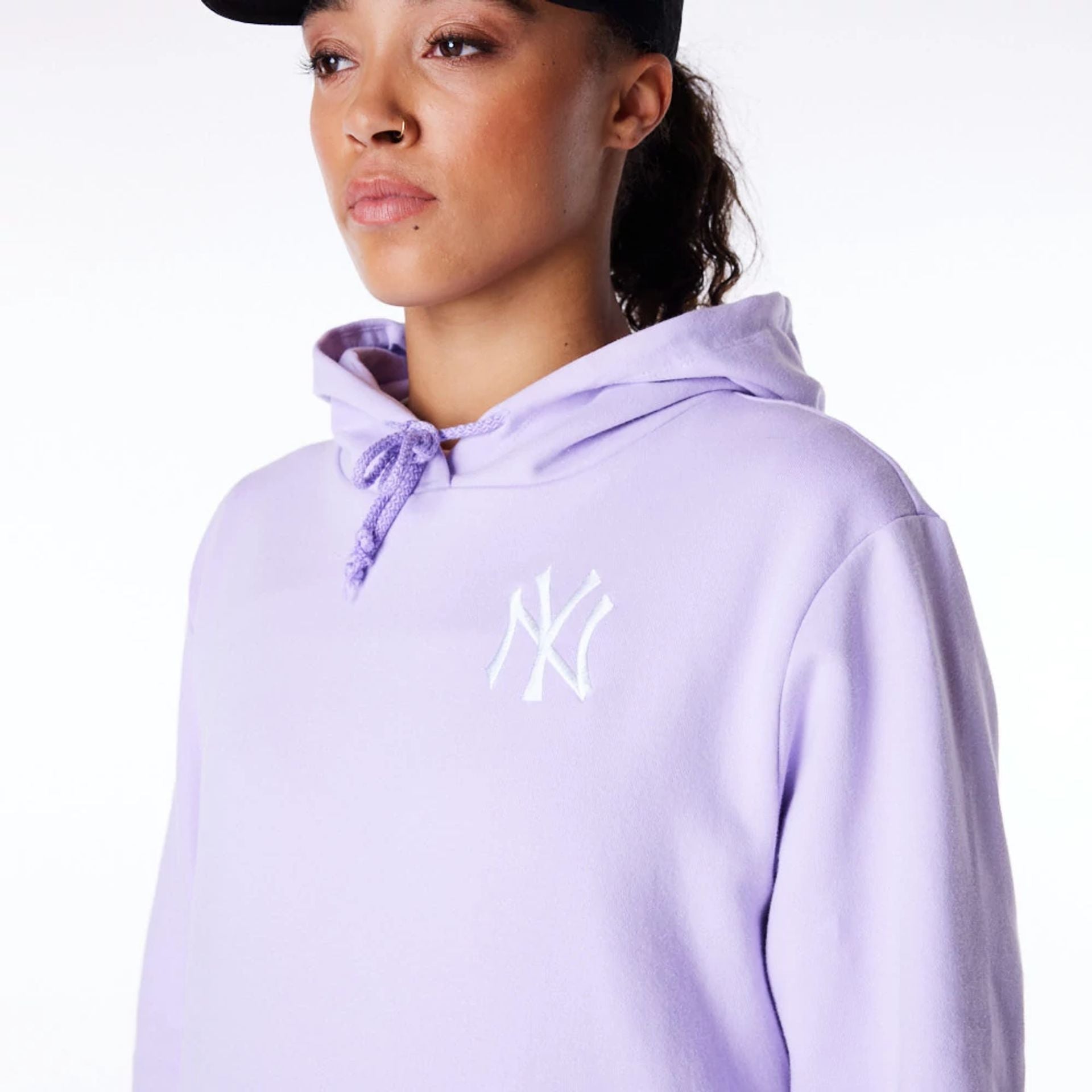 The Female model is wearing New York Yankees Womens MLB League Essential Pastel Purple Pullover Hoodie 9