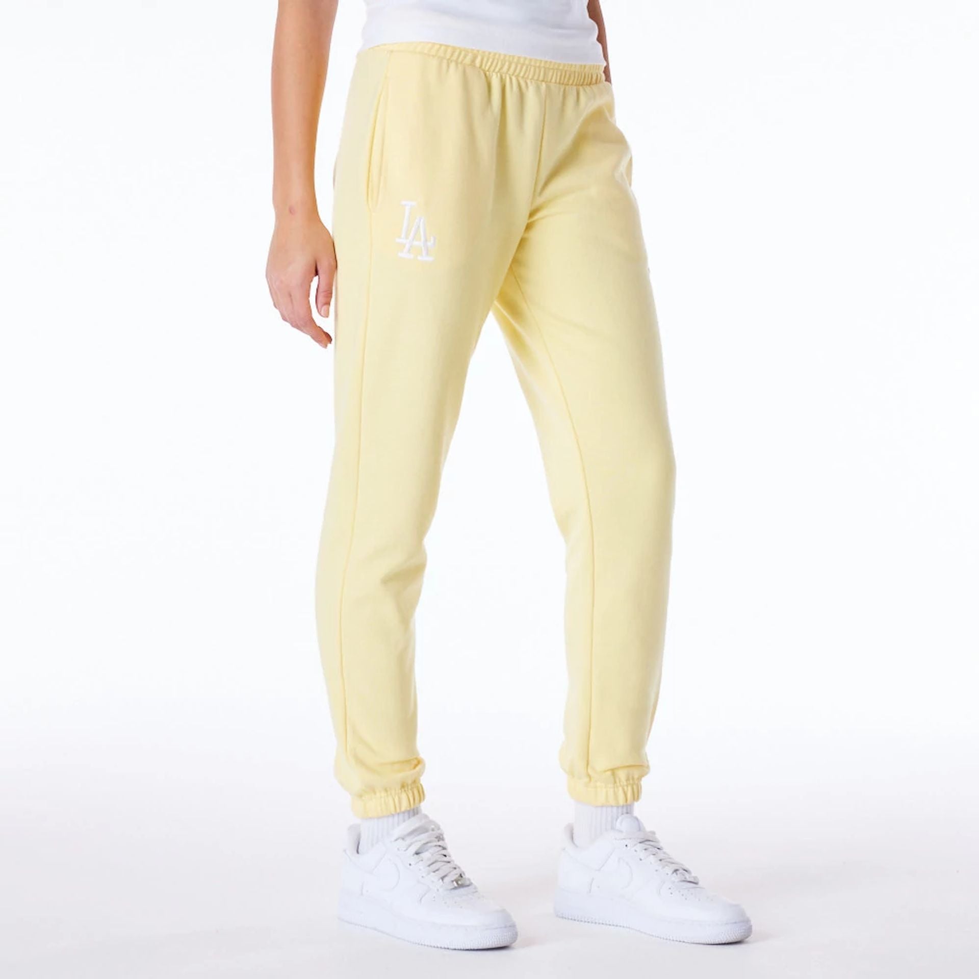 The Female model is wearing LA Dodgers Womens MLB League Essential Pastel Yellow Fleece Joggers 1