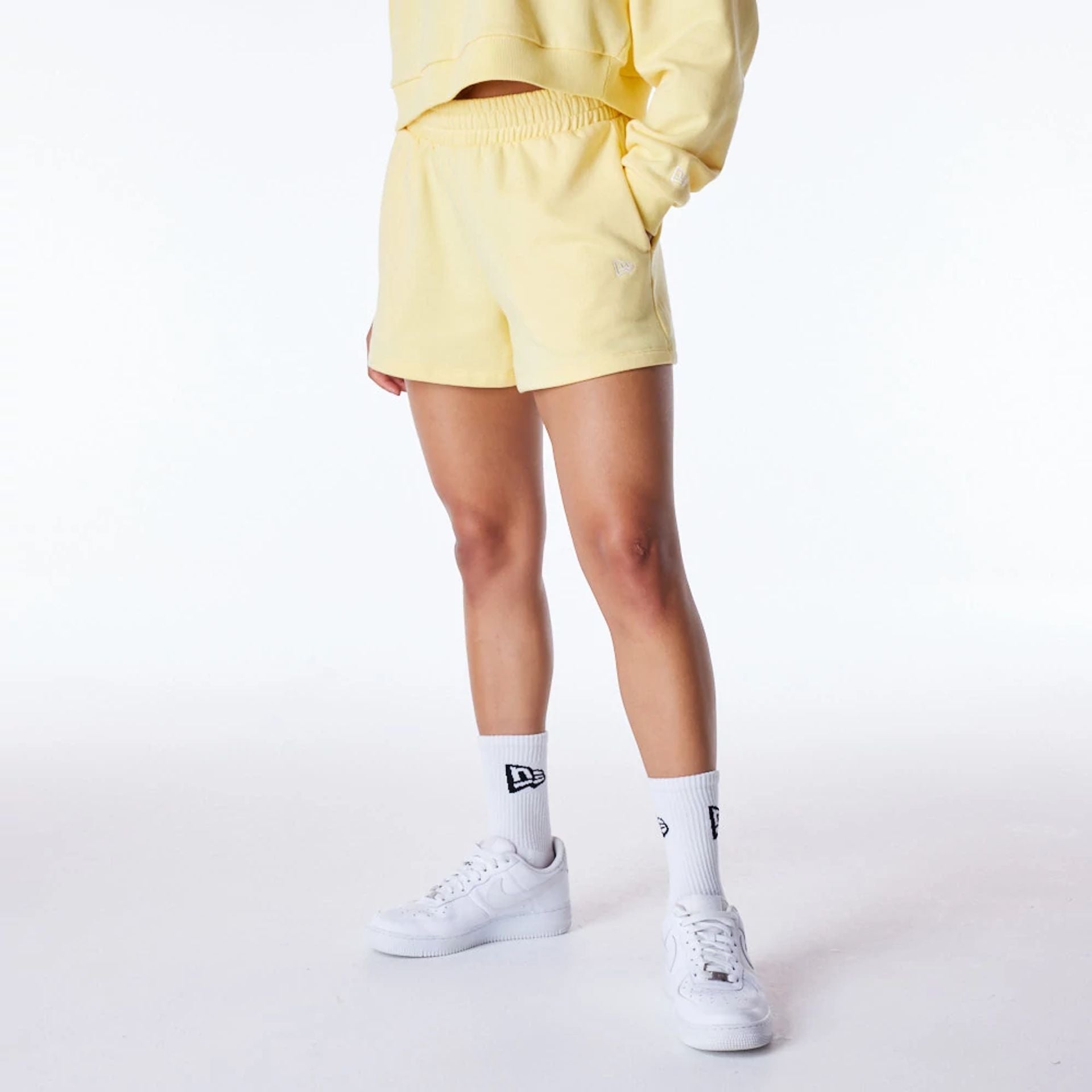 The Female model is wearing LA Dodgers Womens MLB League Essential Pastel Yellow Shorts 8