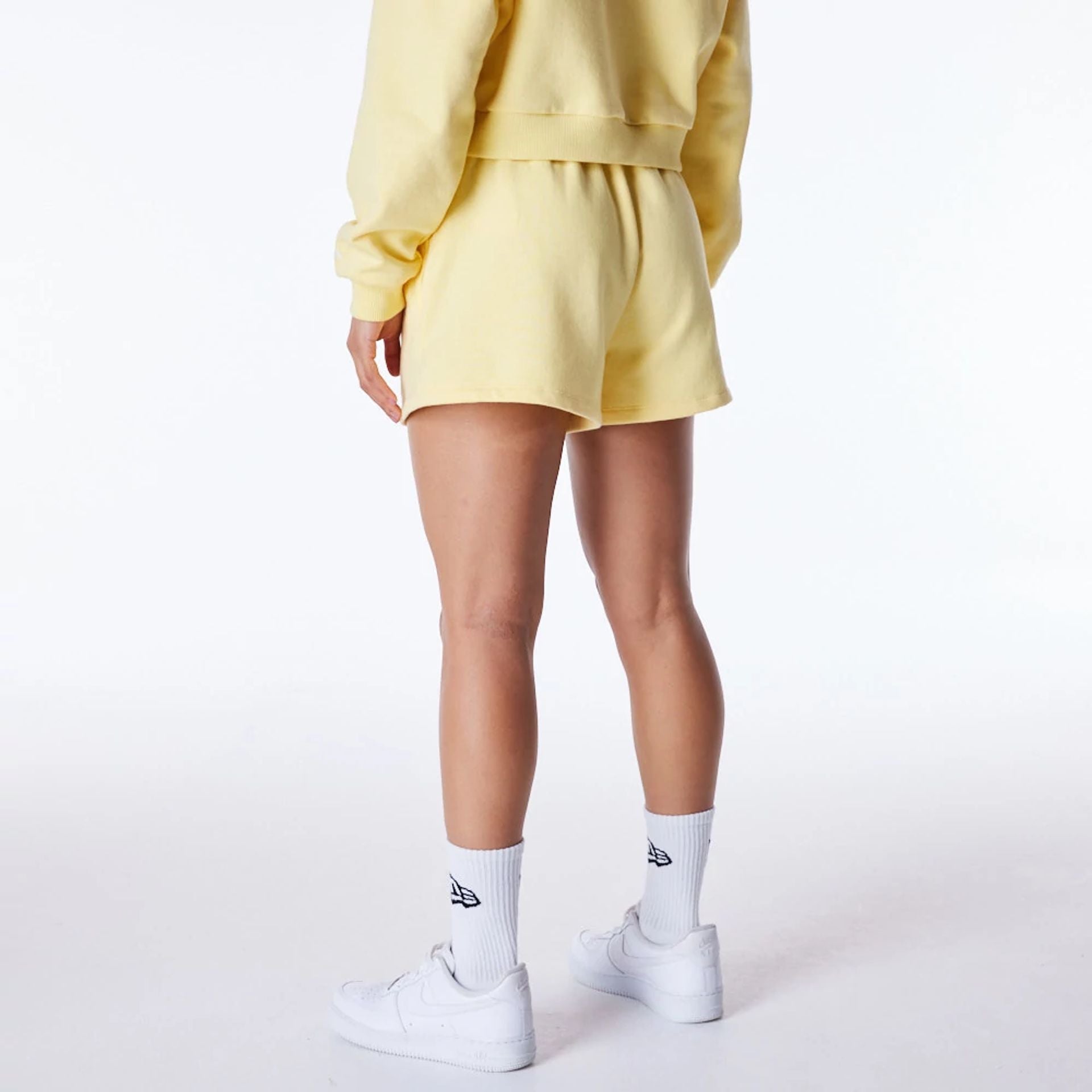 The Female model is wearing LA Dodgers Womens MLB League Essential Pastel Yellow Shorts 4