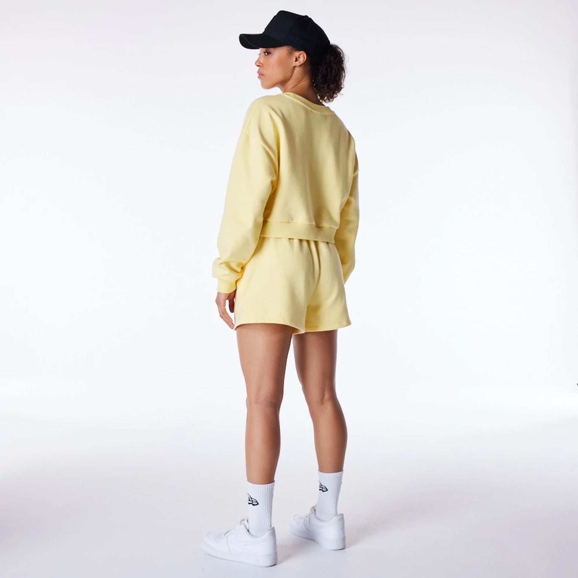 The Female model is wearing LA Dodgers Womens MLB League Essential Pastel Yellow Shorts 2