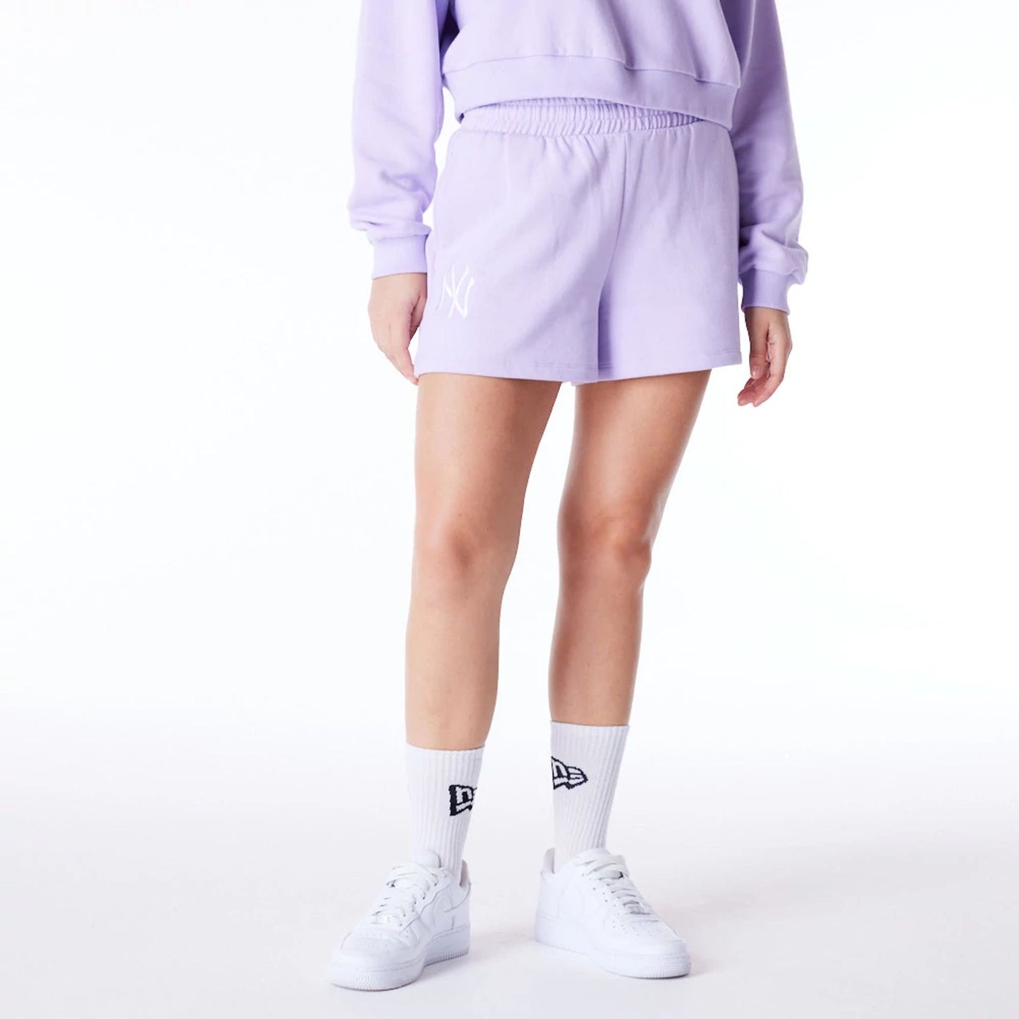 The Female model is wearing New York Yankees Womens MLB League Essential Pastel Purple Shorts 8