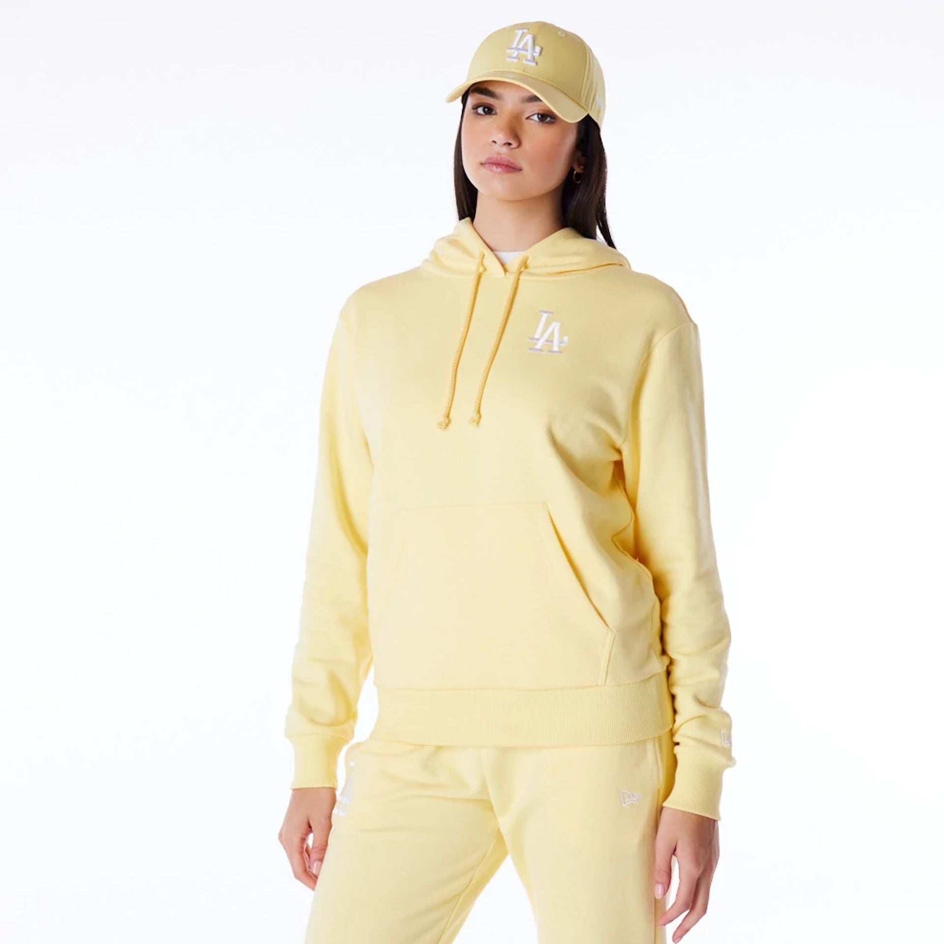 The Female model is wearing LA Dodgers Womens MLB League Essential Pastel Yellow Pullover Hoodie 1