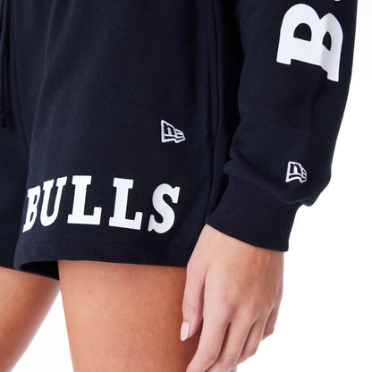 The Female model is wearing Chicago Bulls Womens NBA Wordmark Black Crop Crew Neck Sweatshirt 6