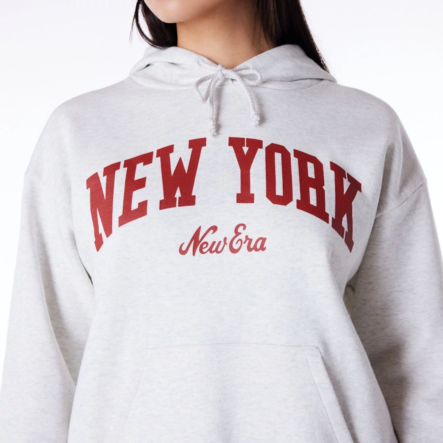 The Female model is wearing New Era Infill Grey Oversized Pullover Hoodie 2