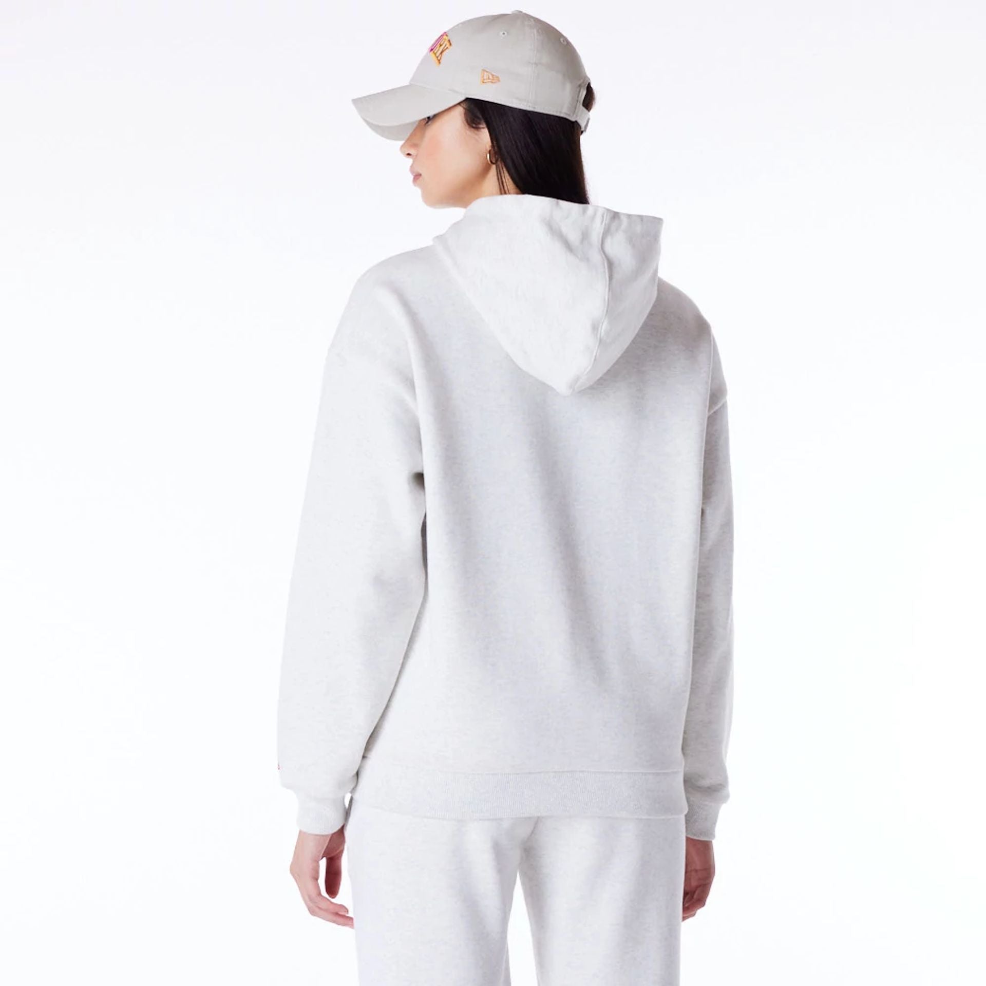 The Female model is wearing New Era Infill Grey Oversized Pullover Hoodie 6