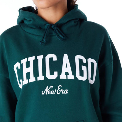 The Female model is wearing New Era Infill Dark Green Oversized Pullover Hoodie 2