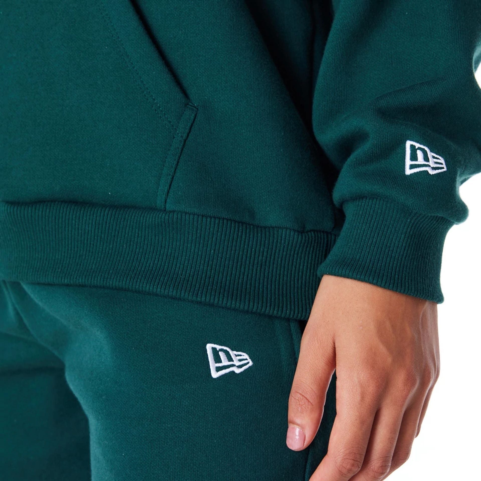 The Female model is wearing New Era Infill Dark Green Oversized Pullover Hoodie 3