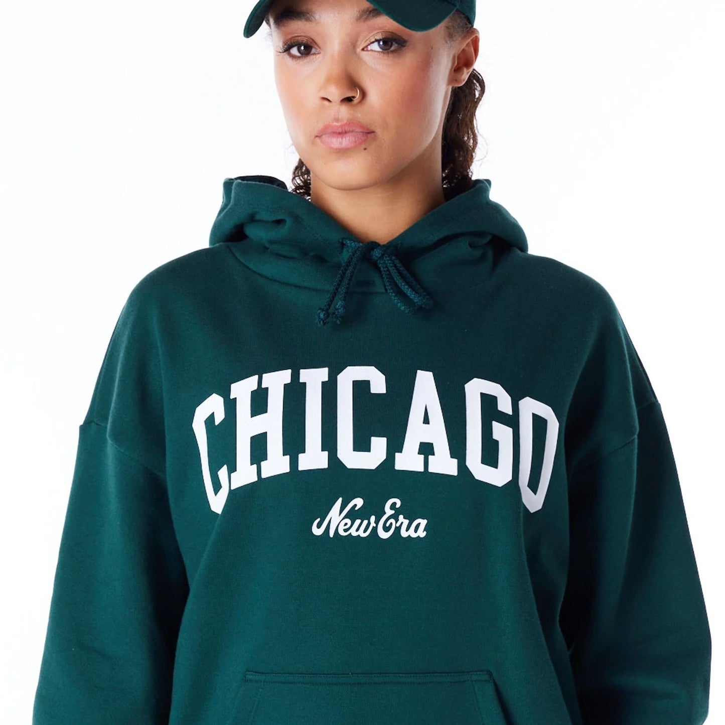 The Female model is wearing New Era Infill Dark Green Oversized Pullover Hoodie 5