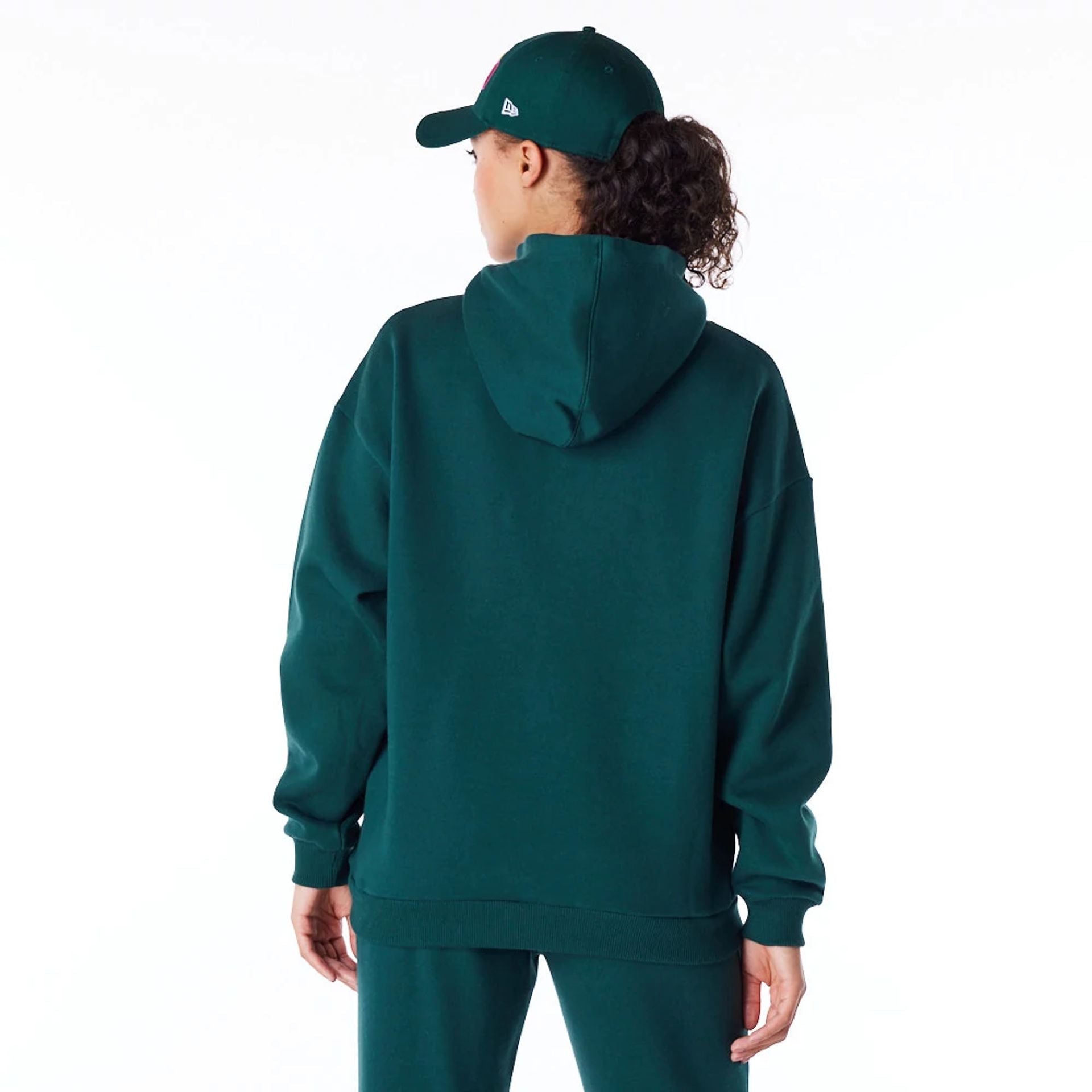 The Female model is wearing New Era Infill Dark Green Oversized Pullover Hoodie 6