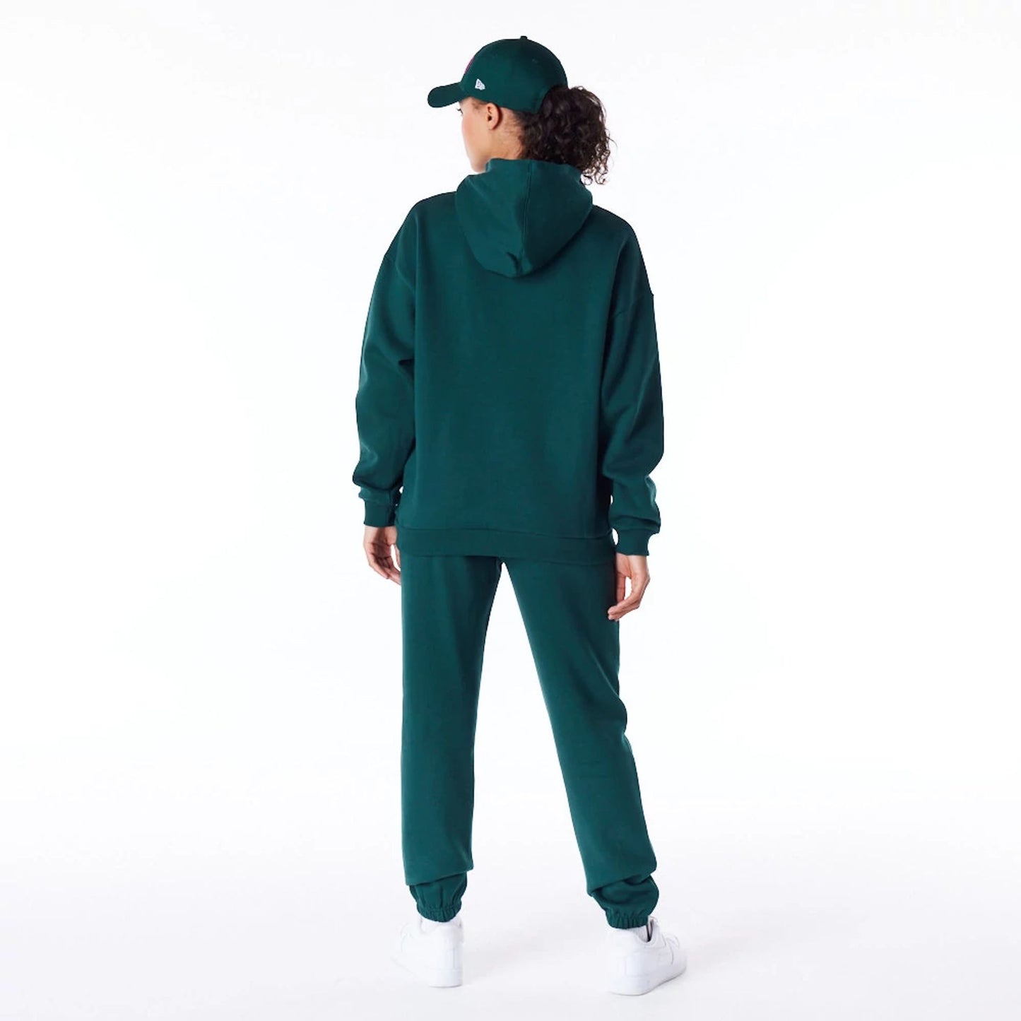 The Female model is wearing New Era Infill Dark Green Oversized Pullover Hoodie 8