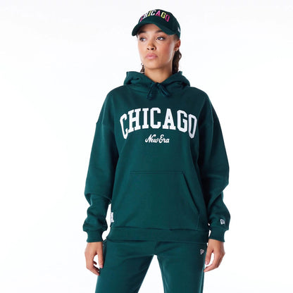 The Female model is wearing New Era Infill Dark Green Oversized Pullover Hoodie 1