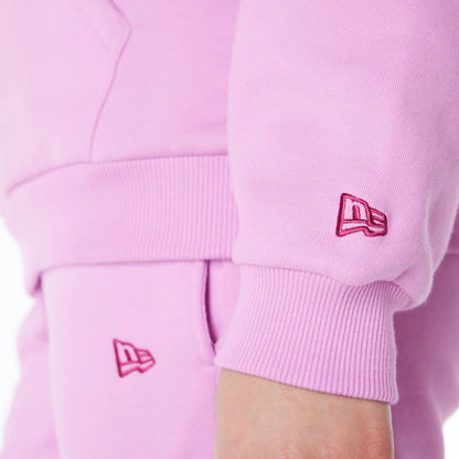 The Female model is wearing New Era Infill Pastel Pink Oversized Pullover Hoodie 5