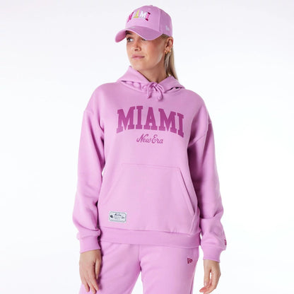 The Female model is wearing New Era Infill Pastel Pink Oversized Pullover Hoodie 6