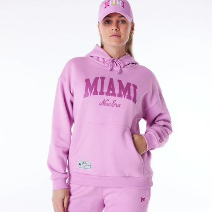 The Female model is wearing New Era Infill Pastel Pink Oversized Pullover Hoodie 1