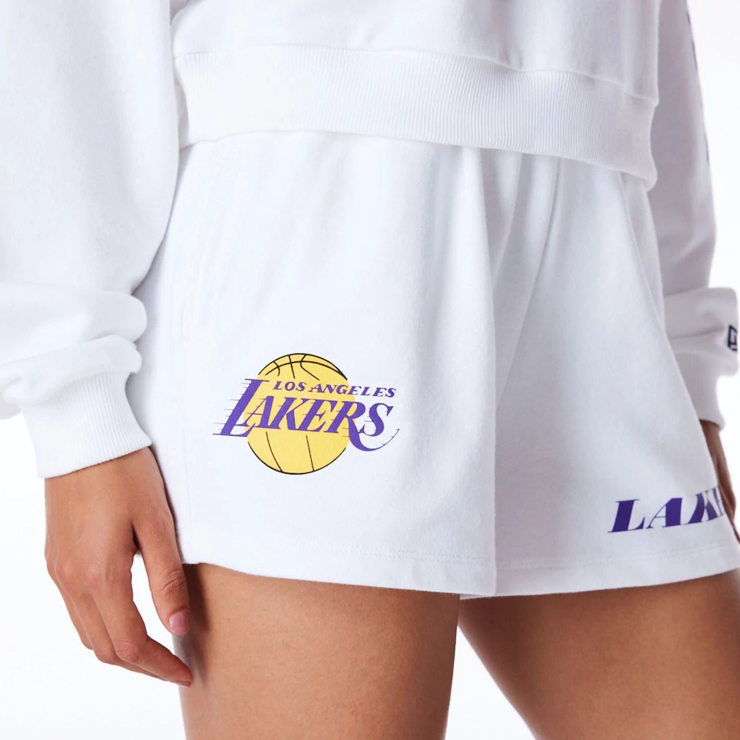 The Female model is wearing LA Lakers Womens NBA Wordmark White Shorts 7