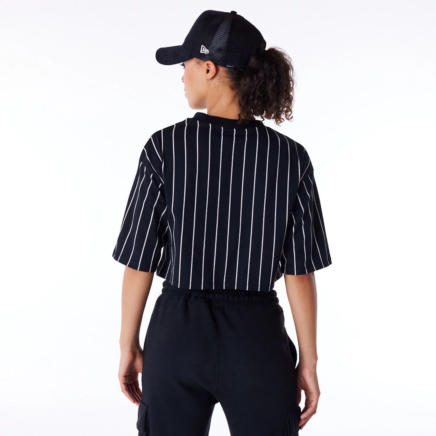 The Female model is wearing New Era Womens Pinstripe Black Crop T-Shirt 5