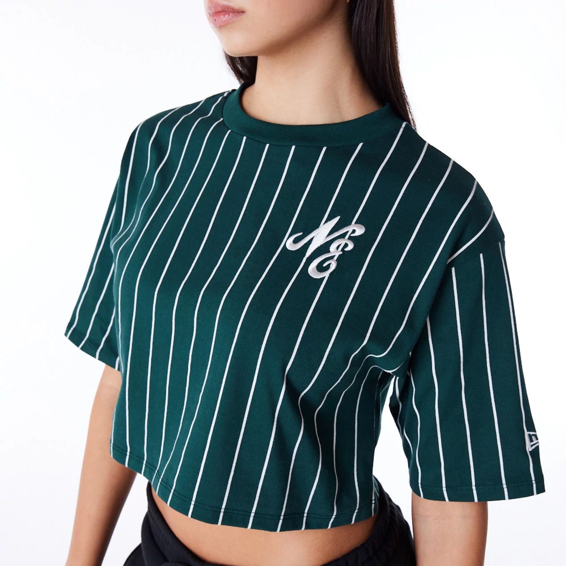 The Female model is wearing New Era Womens Pinstripe Dark Green Crop T-Shirt 2