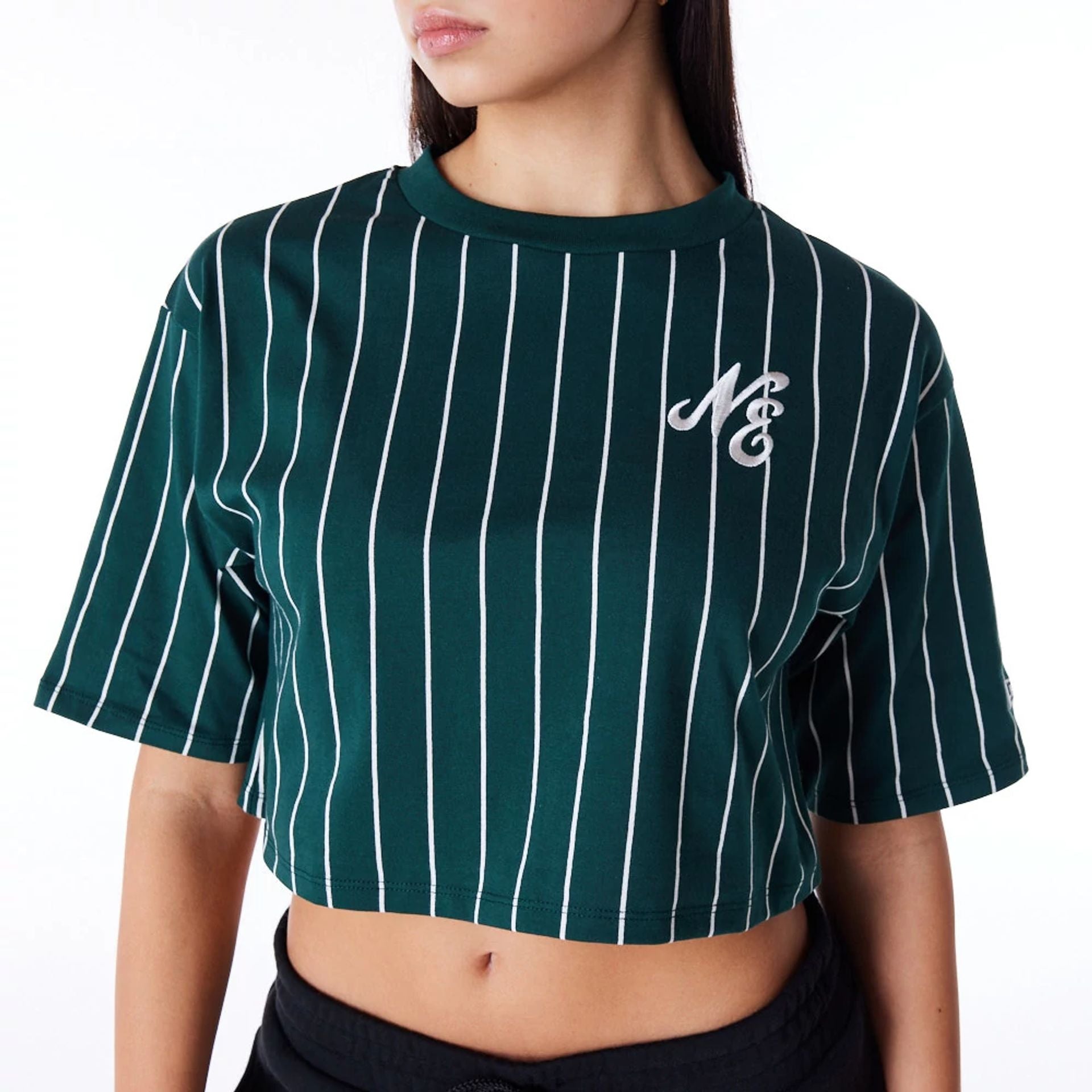 The Female model is wearing New Era Womens Pinstripe Dark Green Crop T-Shirt 5