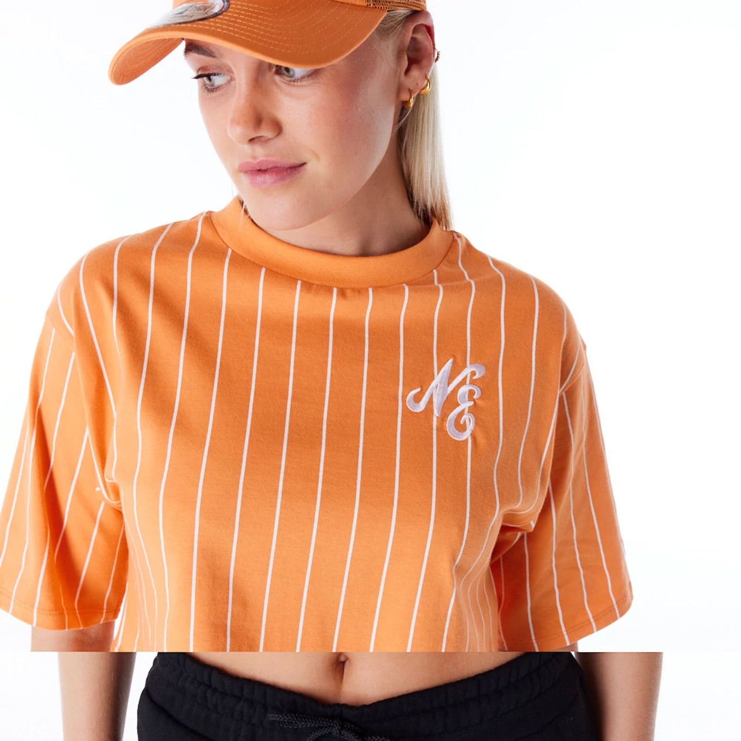 The Female model is wearing New Era Womens Pinstripe Orange Crop T-Shirt 2