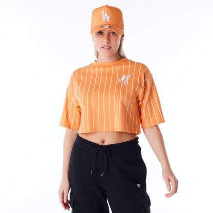 The Female model is wearing New Era Womens Pinstripe Orange Crop T-Shirt 1