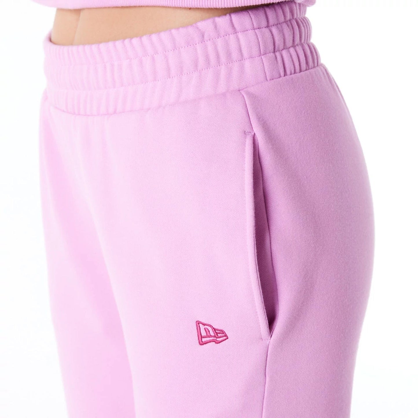 The Female model is wearing New Era Infill Pastel Pink Fleece Joggers 3