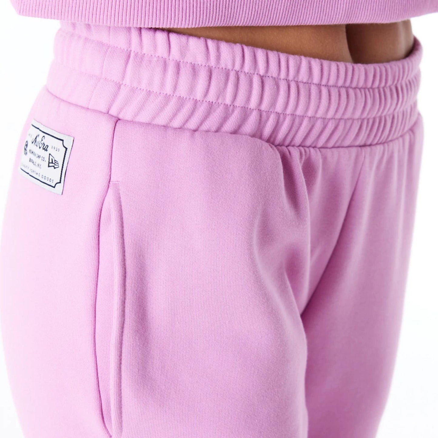 The Female model is wearing New Era Infill Pastel Pink Fleece Joggers 6