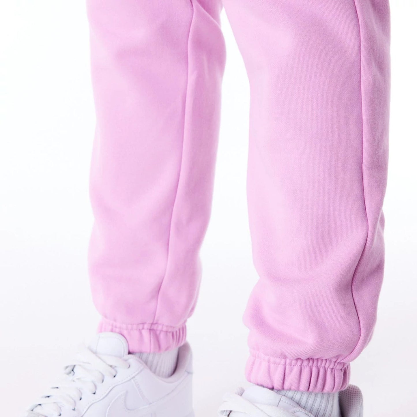 The Female model is wearing New Era Infill Pastel Pink Fleece Joggers 7