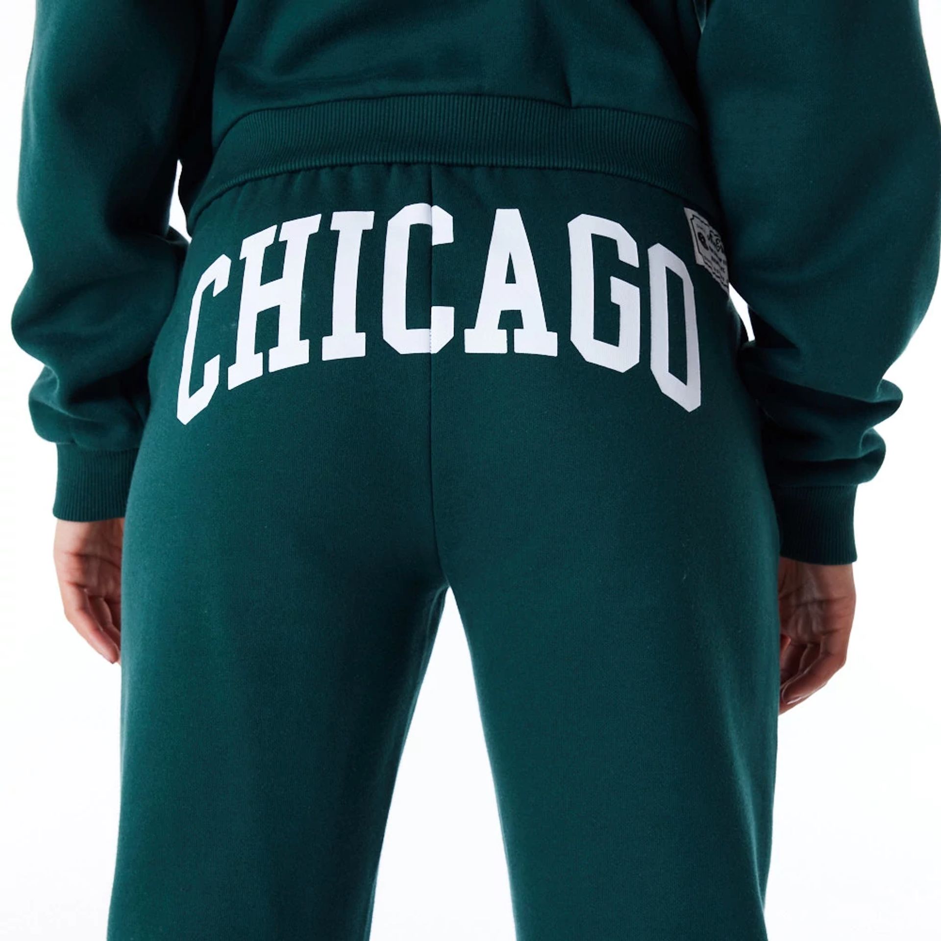 The Female model is wearing New Era Infill Dark Green Fleece Joggers 4