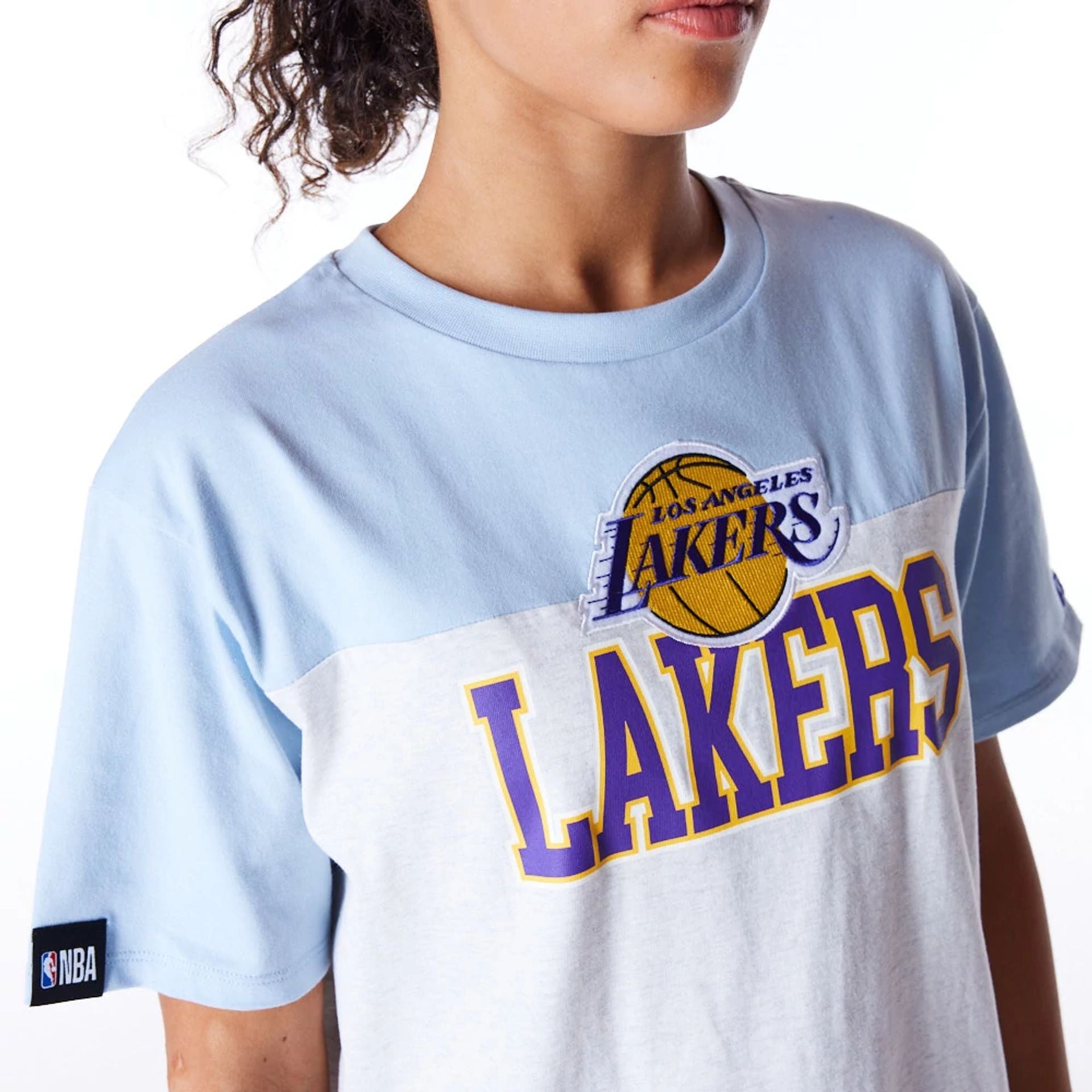 The Female model is wearing LA Lakers Womens NBA Pastel Blue Oversized T-Shirt 4