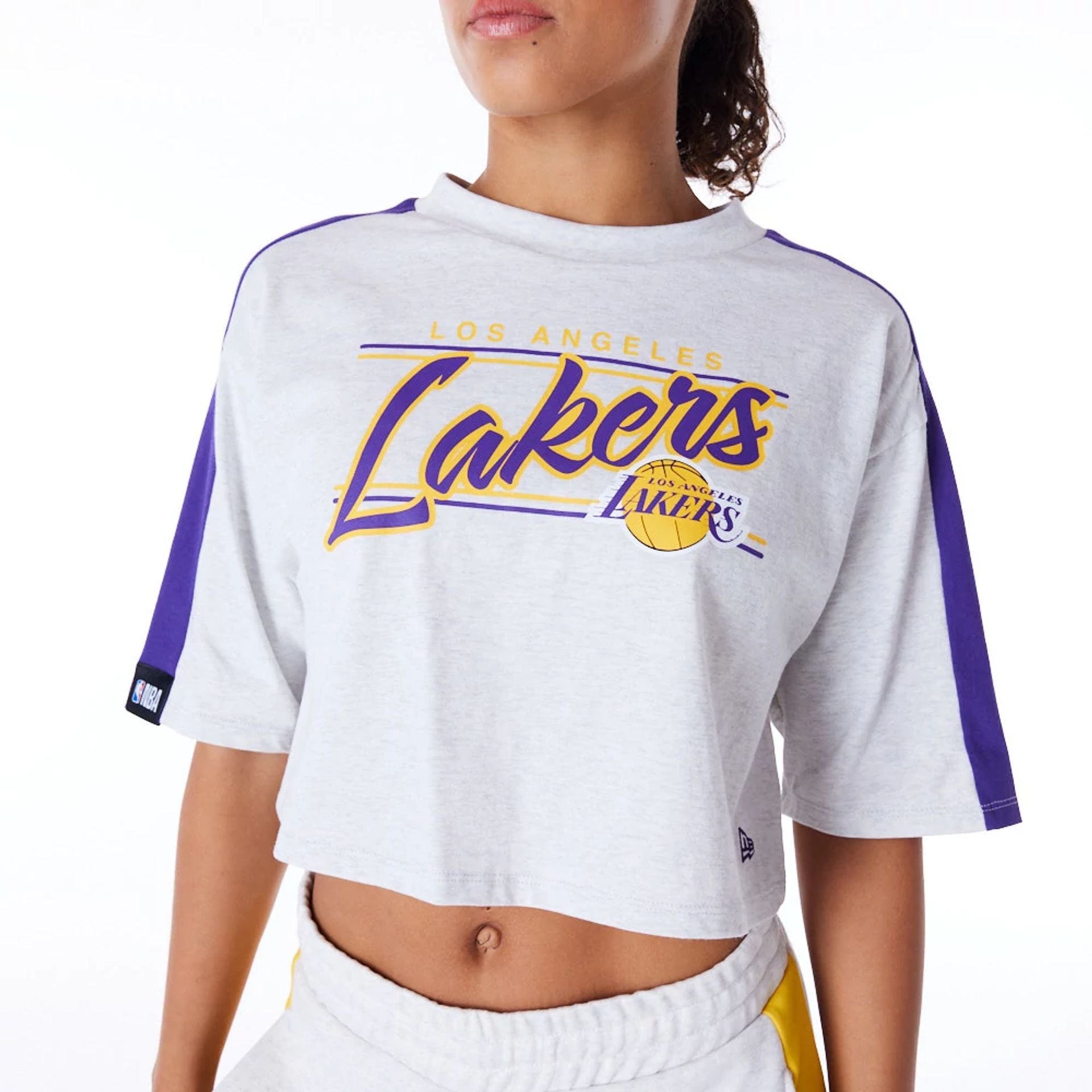 The Female model is wearing LA Lakers Womens NBA Colour Block Grey Crop T-Shirt 2