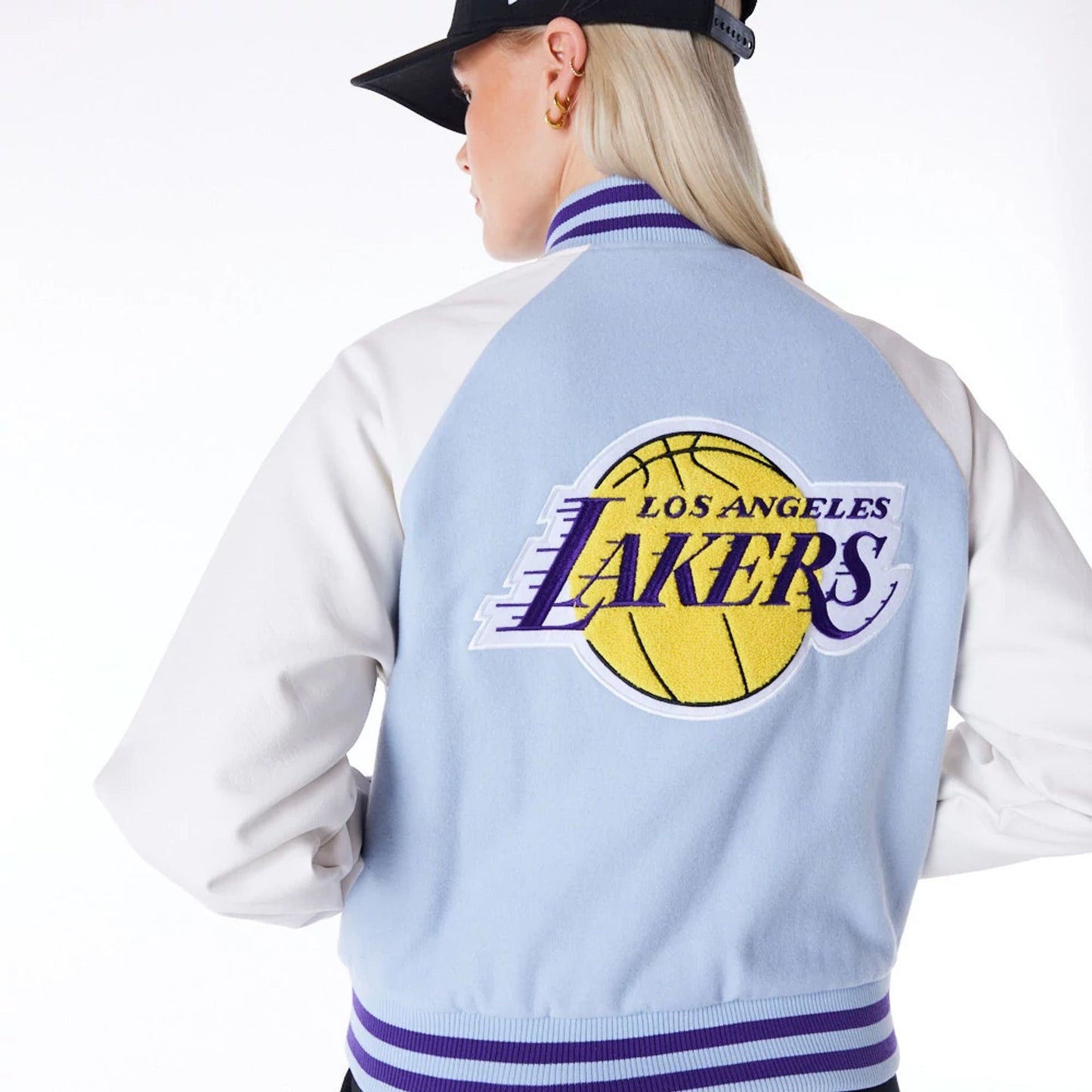 The Female model is wearing LA Lakers Womens NBA Pastel Blue Varsity Jacket 8