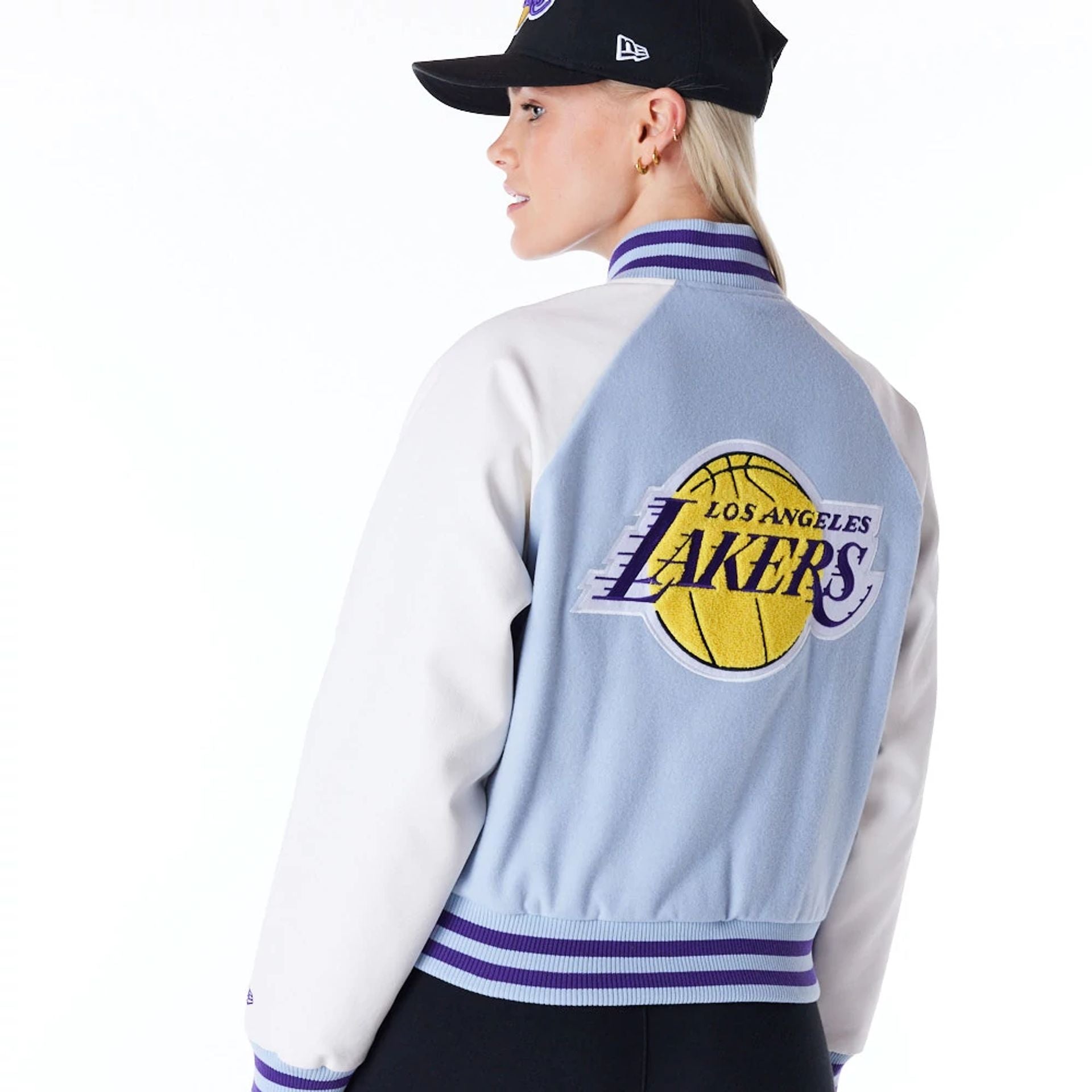 The Female model is wearing LA Lakers Womens NBA Pastel Blue Varsity Jacket 3