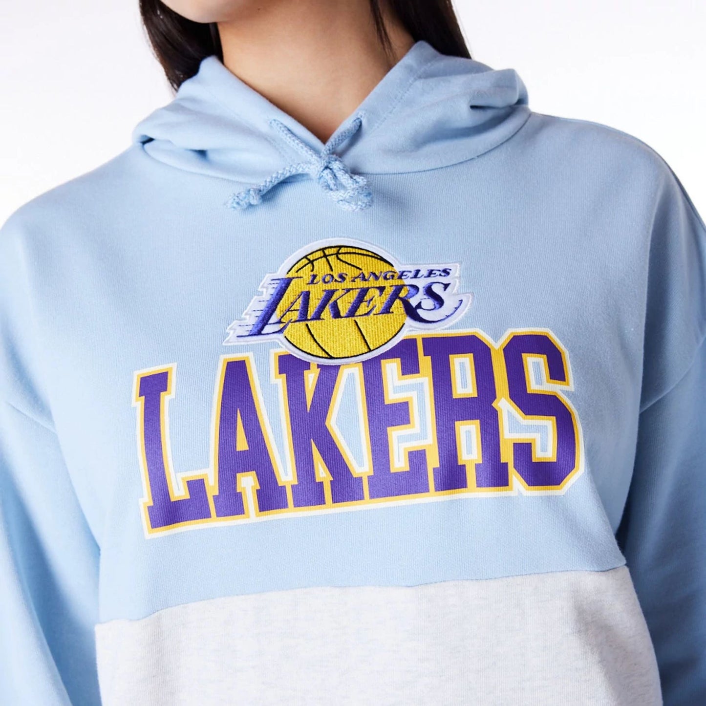 The Female model is wearing LA Lakers Womens NBA Pastel Blue Oversized Pullover Hoodie 5