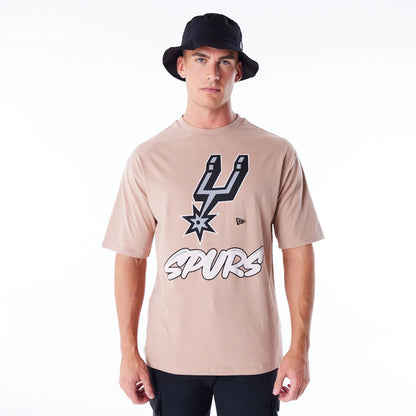 The Male model is wearing San Antonio Spurs NBA Wordmark Beige Oversized T-Shirt 1