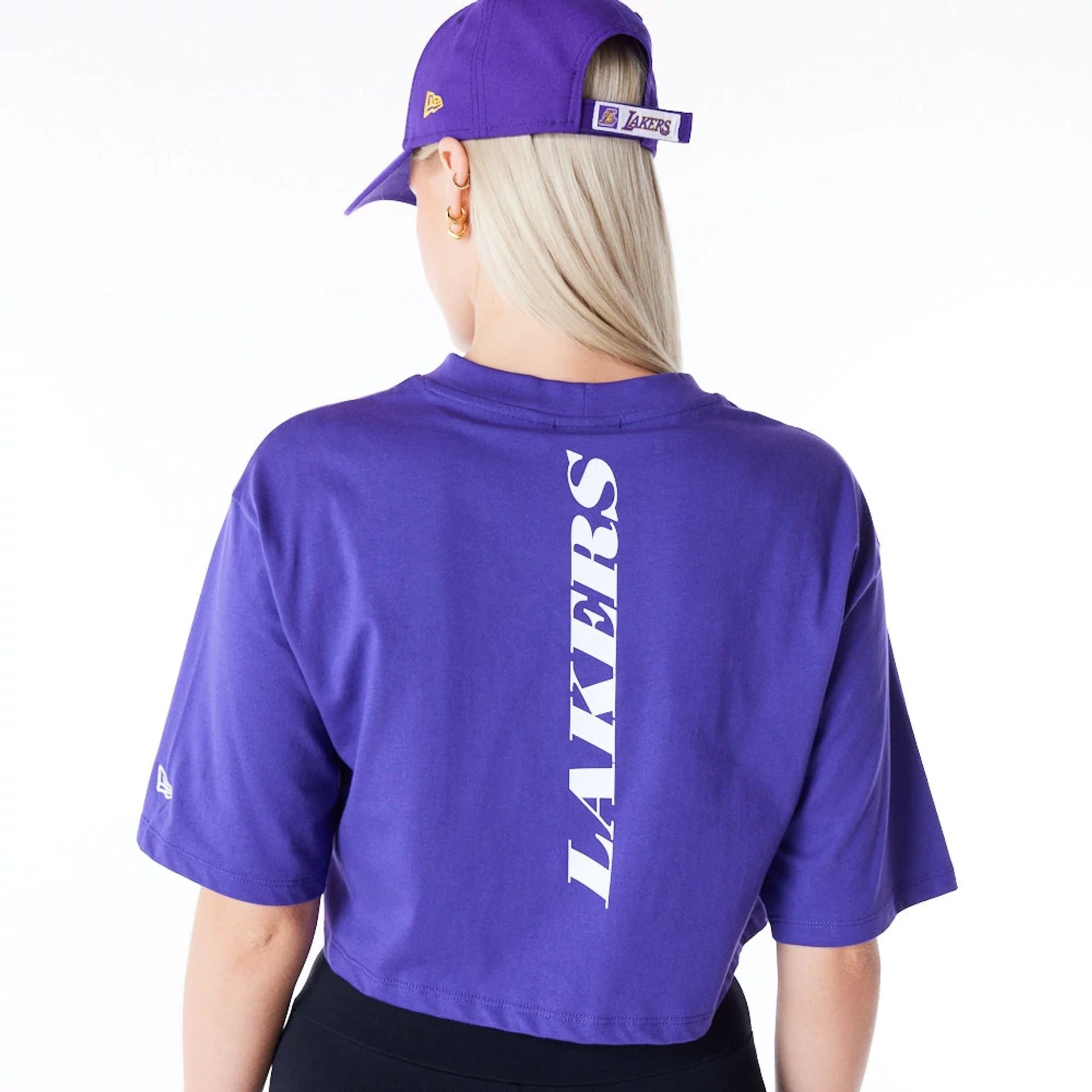 The Female model is wearing LA Lakers Womens NBA Team Logo Wordmark Purple Crop T-Shirt 6