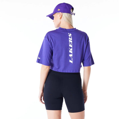 The Female model is wearing LA Lakers Womens NBA Team Logo Wordmark Purple Crop T-Shirt 3