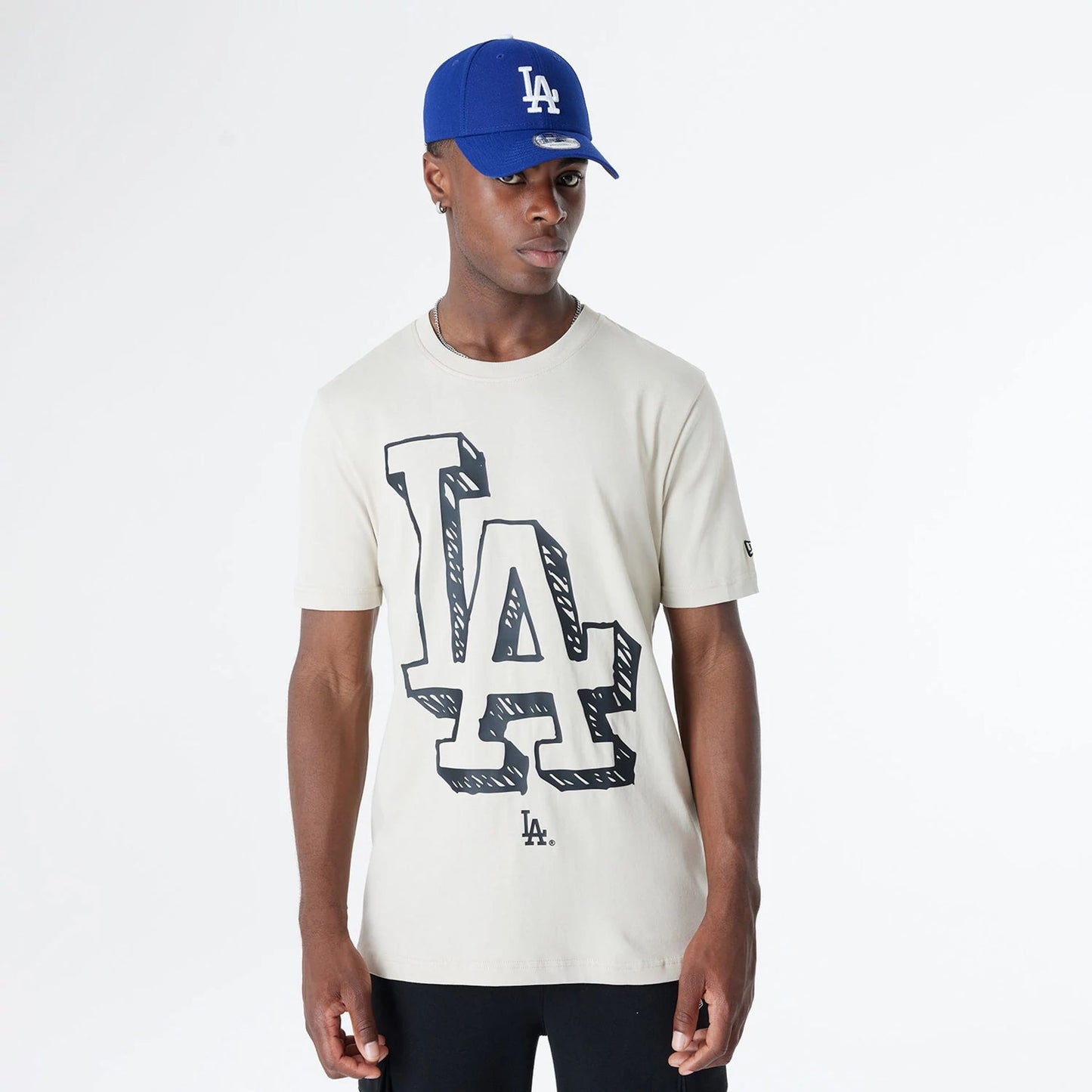 The Male model is wearing LA Dodgers Official Doodles Light Beige T-Shirt 7