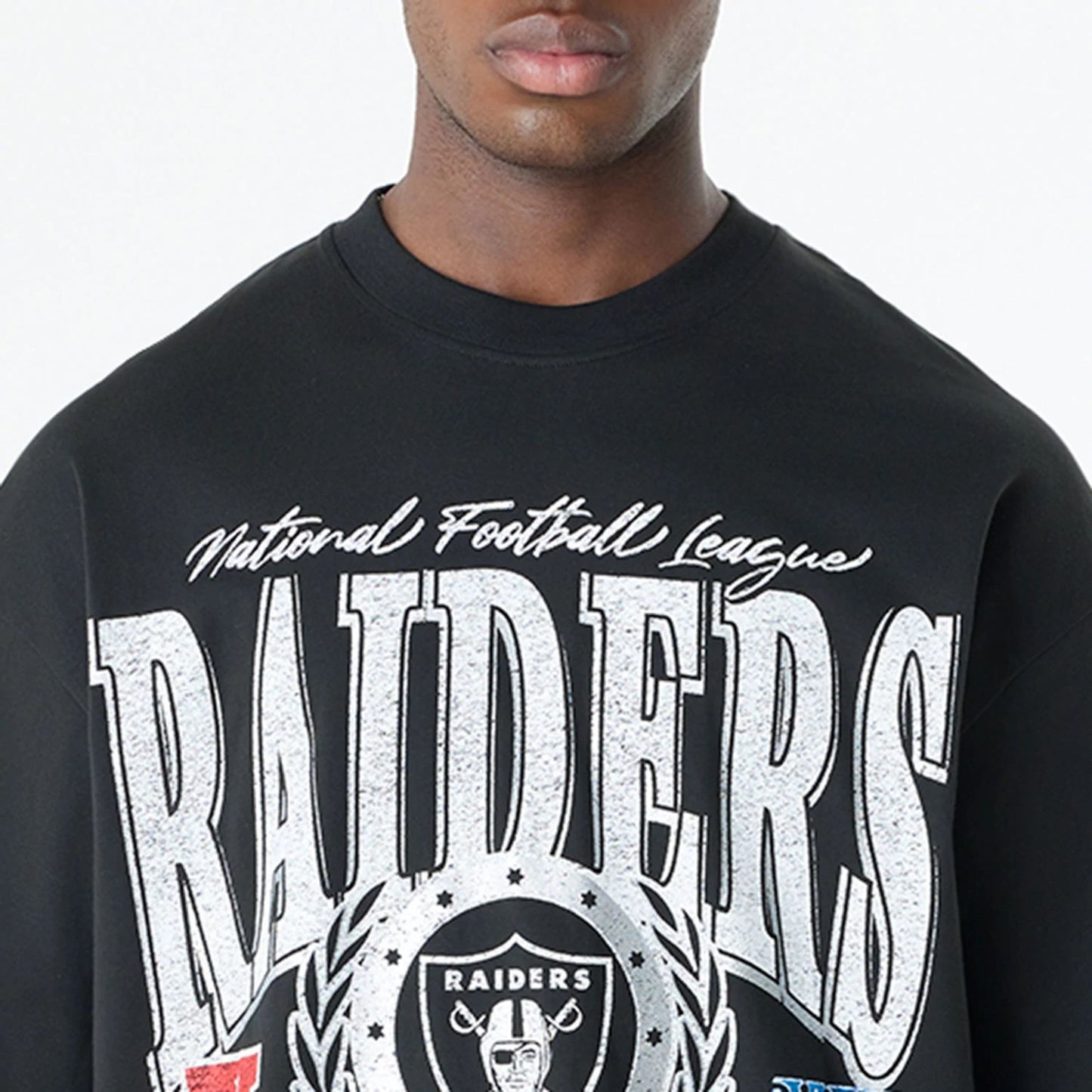 The Male model is wearing Las Vegas Raiders Oversized Essential Black Oversized T-Shirt 5