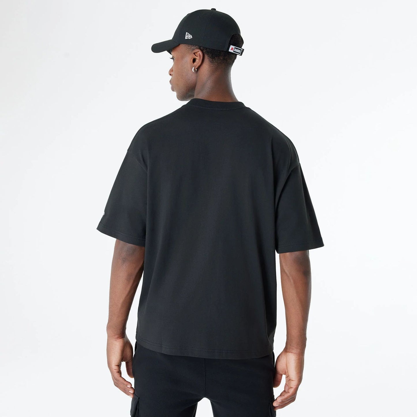 The Male model is wearing Las Vegas Raiders Oversized Essential Black Oversized T-Shirt 2