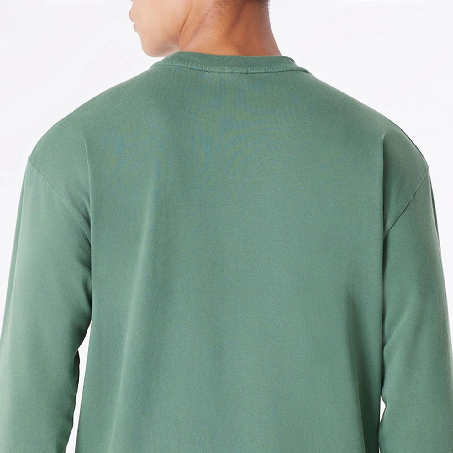 The Male model is wearing Milwaukee Bucks Oversized Essential Dark Green Oversized Long Sleeve T-Shirt 7