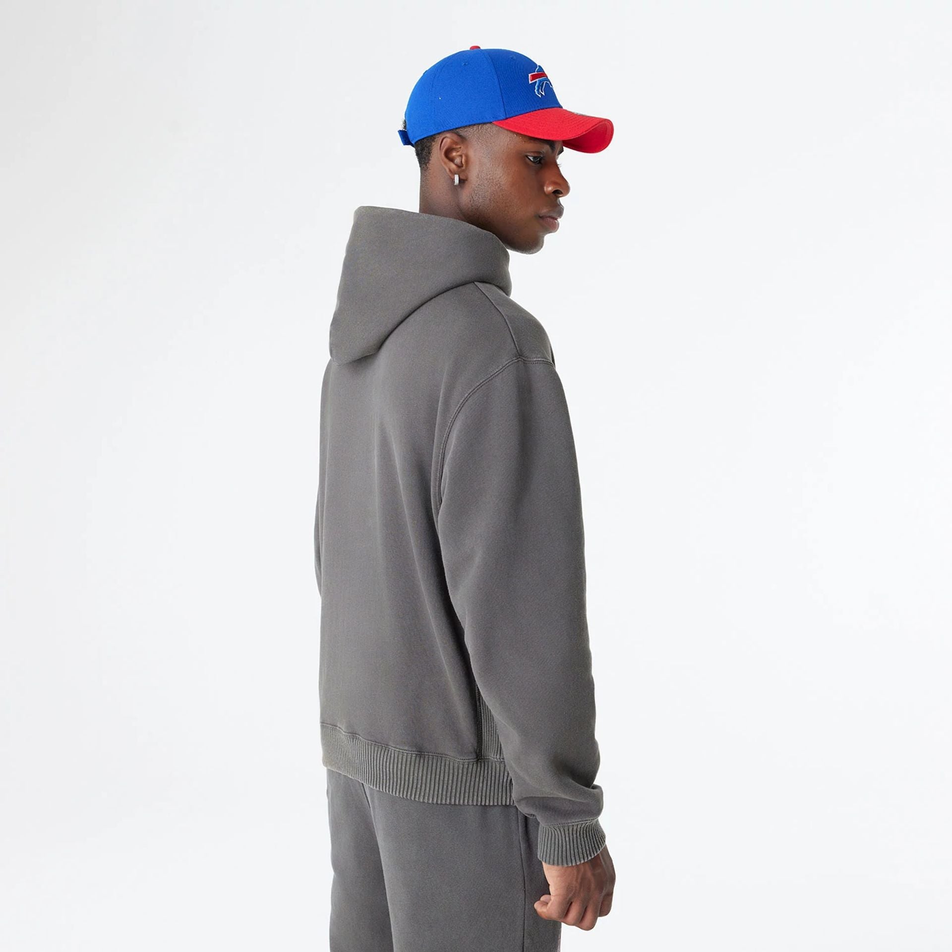 The Male model is wearing Buffalo Bills Oversized Essential Dark Grey Oversized Pullover Hoodie 8