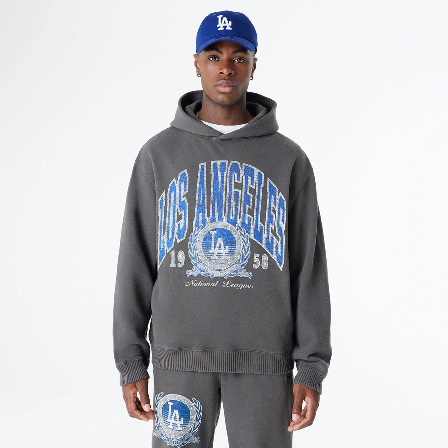 The Male model is wearing LA Dodgers Oversized Essential Dark Grey Oversized Pullover Hoodie 1