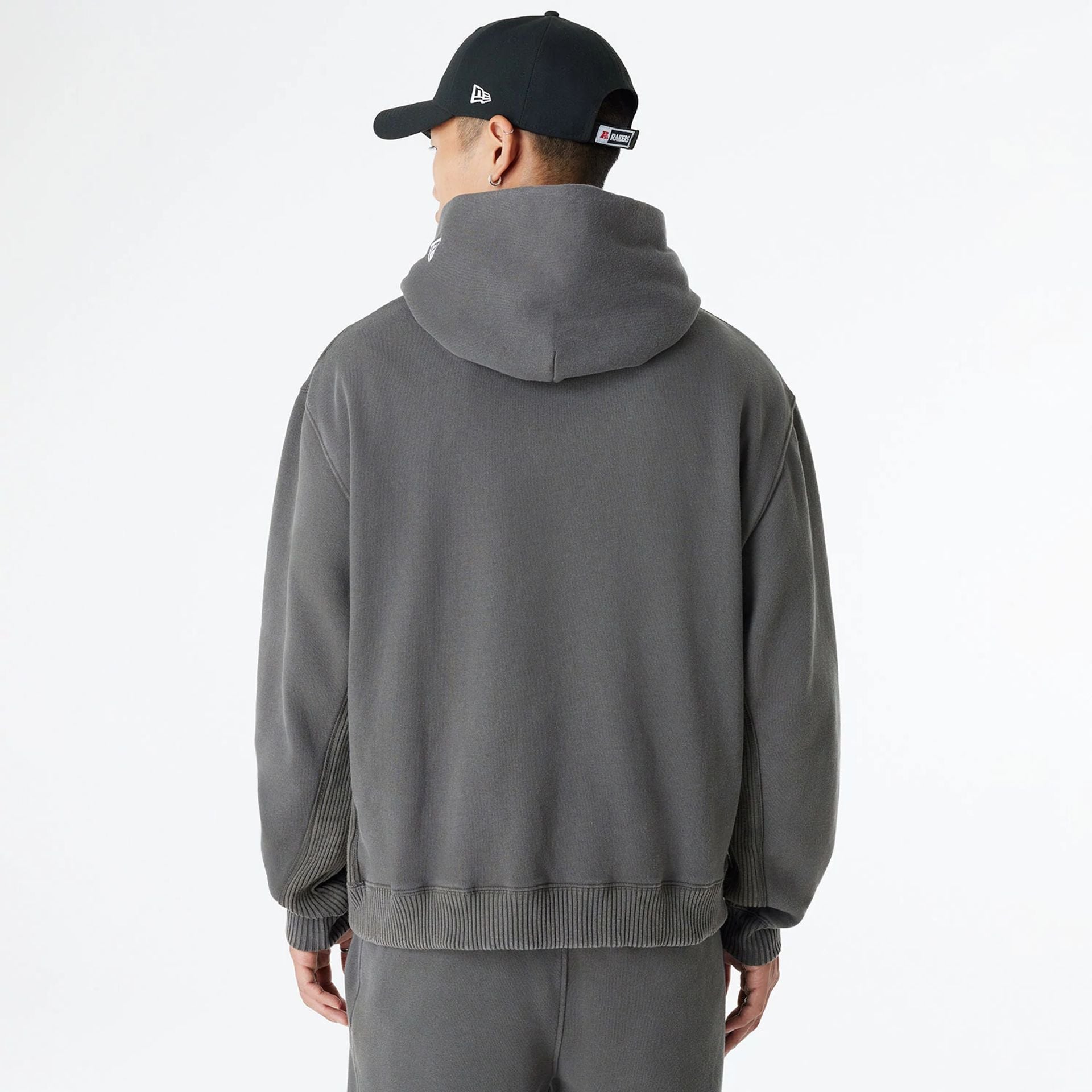 The Male model is wearing Las Vegas Raiders Oversized Essential Dark Grey Oversized Pullover Hoodie 2